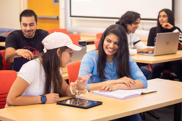 Students in a small classroom with mobile devices